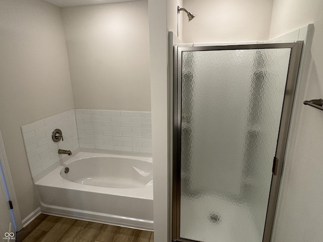 bathroom featuring hardwood / wood-style floors and shower with separate bathtub