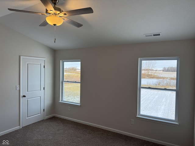 carpeted empty room featuring ceiling fan, a textured ceiling, and vaulted ceiling