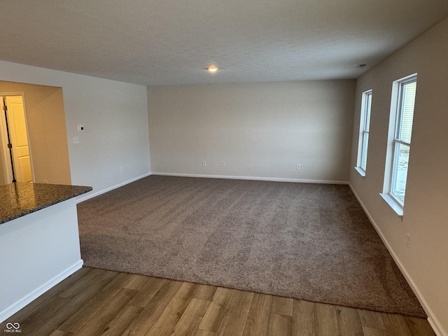 interior space featuring dark hardwood / wood-style flooring and a textured ceiling