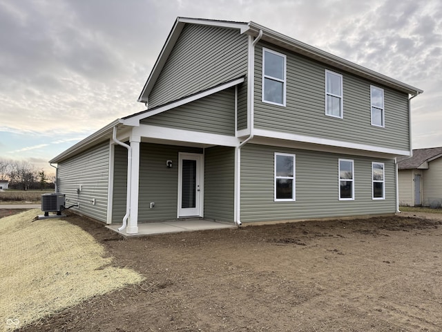 back of property featuring central AC unit and a patio area