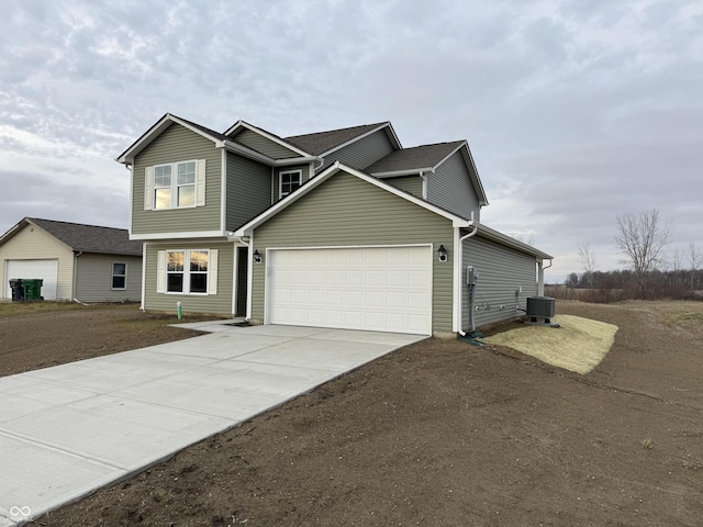 view of front of house featuring central air condition unit and a garage