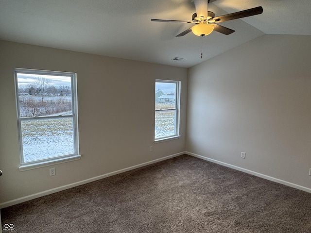 carpeted empty room with ceiling fan and lofted ceiling