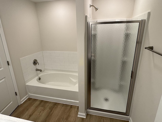 bathroom with separate shower and tub and wood-type flooring