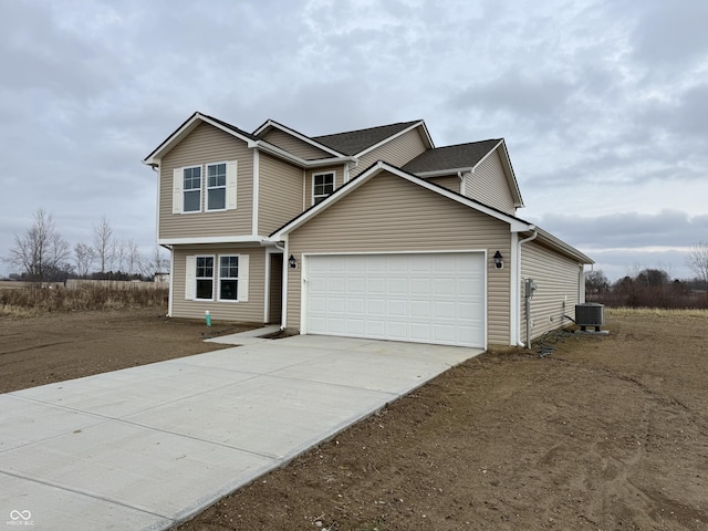 view of front of property with central air condition unit and a garage