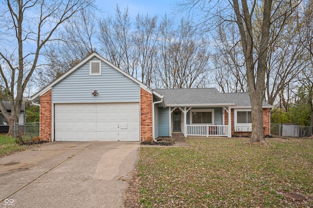 ranch-style house featuring covered porch, a front yard, and a garage