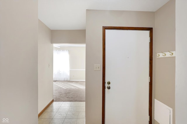 hallway featuring light colored carpet