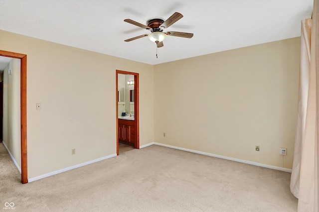 spare room with light colored carpet and ceiling fan