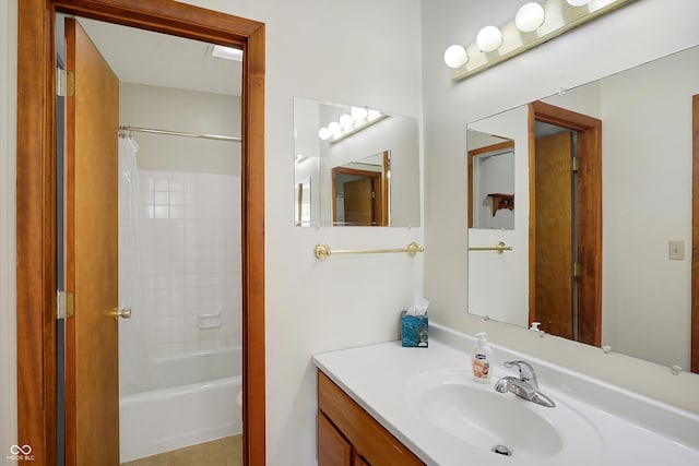 bathroom featuring vanity, shower / bath combo with shower curtain, and tile patterned flooring