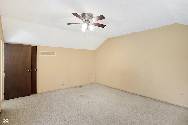 additional living space with lofted ceiling, light colored carpet, and ceiling fan