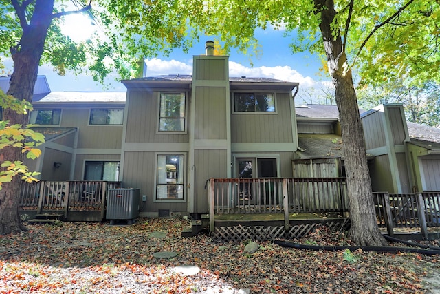 rear view of property with cooling unit and a deck