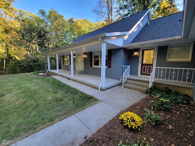 view of front of home with a front yard and covered porch