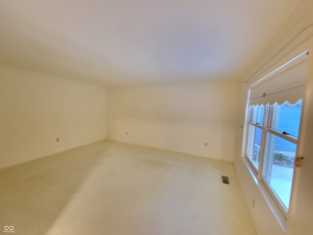 carpeted empty room with a water view