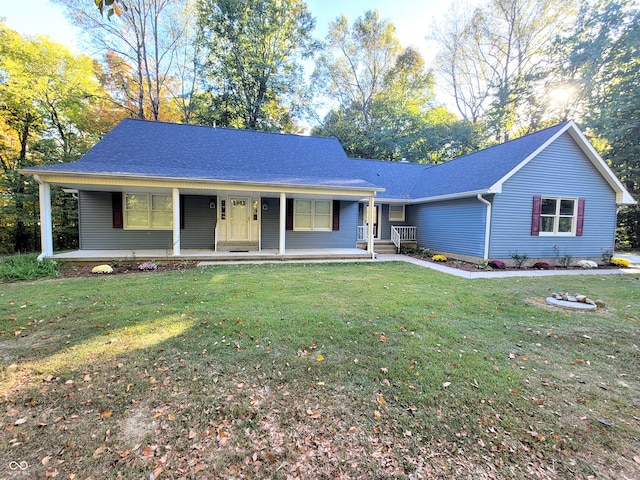 ranch-style home featuring covered porch and a front lawn