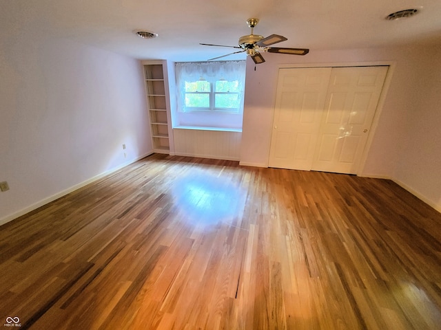 empty room with wood-type flooring and ceiling fan