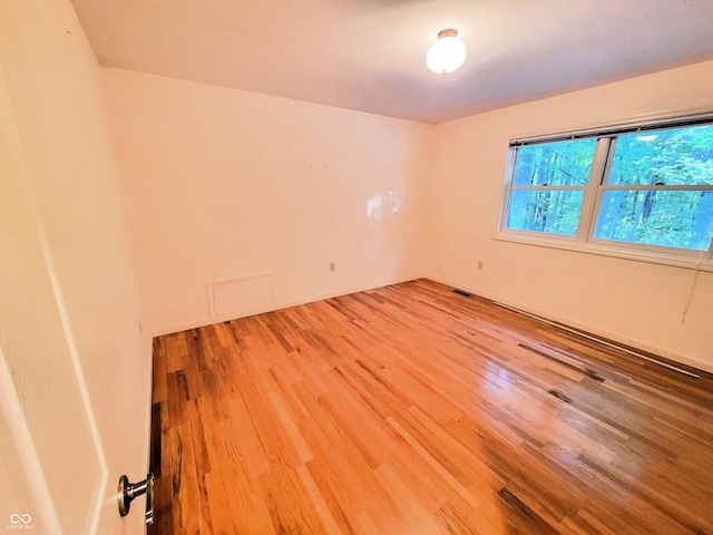 unfurnished room featuring hardwood / wood-style floors