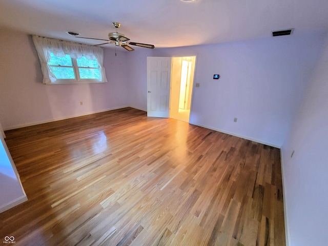 unfurnished room featuring hardwood / wood-style floors and ceiling fan