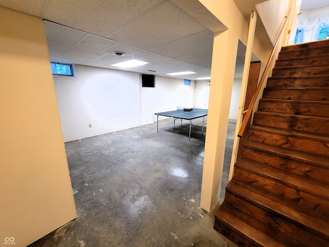 basement featuring a drop ceiling