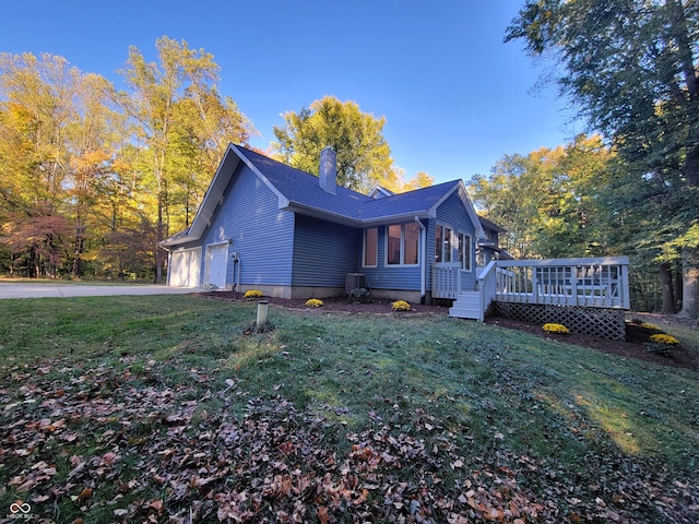 view of property exterior featuring a yard, a deck, and a garage