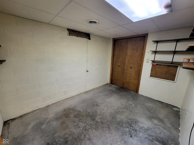 basement with a paneled ceiling