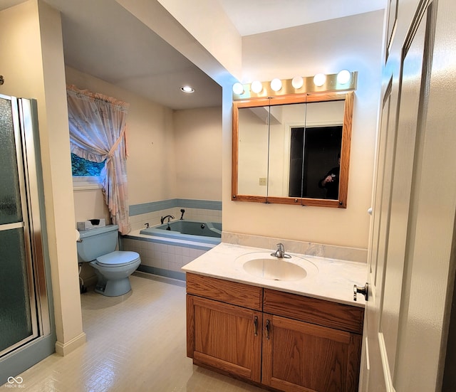 bathroom with vanity, toilet, a relaxing tiled tub, and tile patterned floors