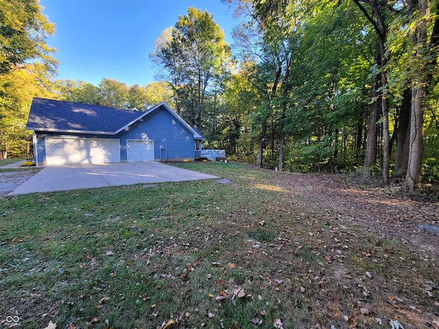 view of side of home featuring a yard and a garage