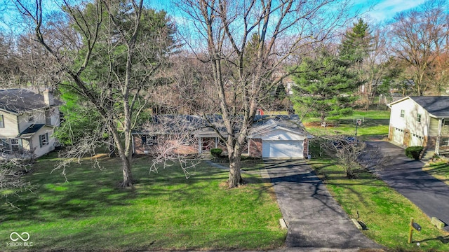 view of front of home with a garage, a water view, and a front yard