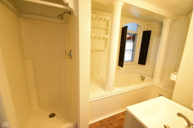 bathroom with vanity, ornate columns, a shower, and wood-type flooring