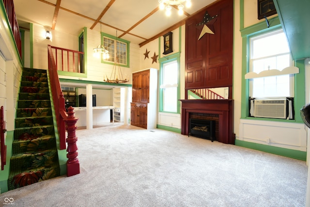 carpeted living room with a towering ceiling and cooling unit