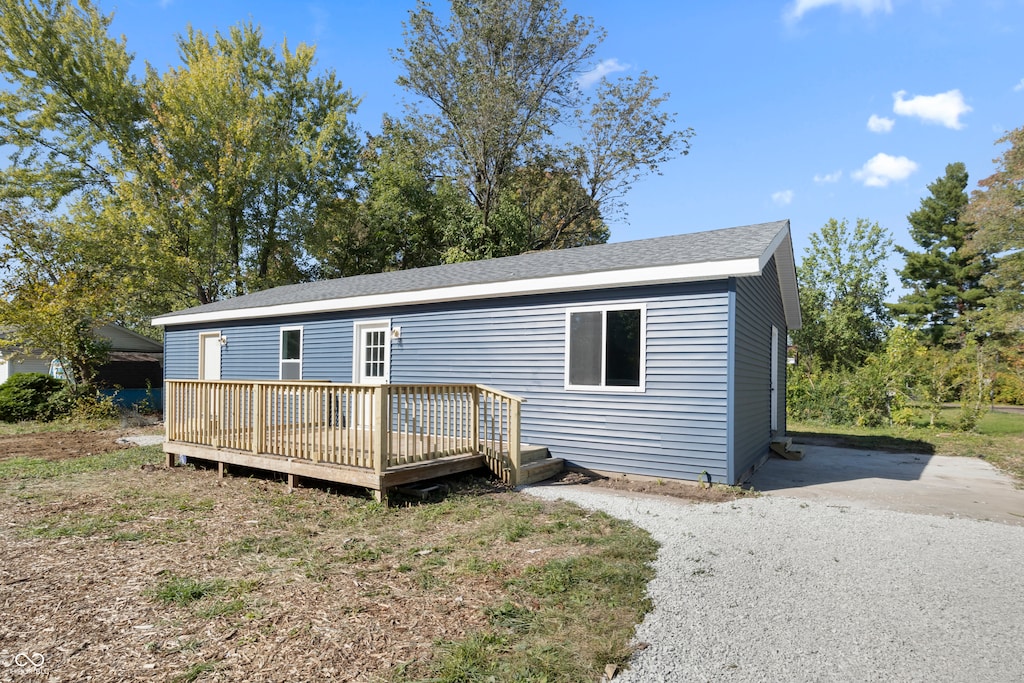 back of property featuring a wooden deck