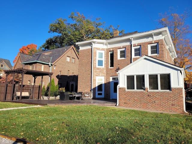 back of house with a patio area and a lawn