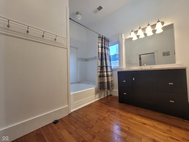 bathroom with vanity, hardwood / wood-style floors, and shower / bath combo