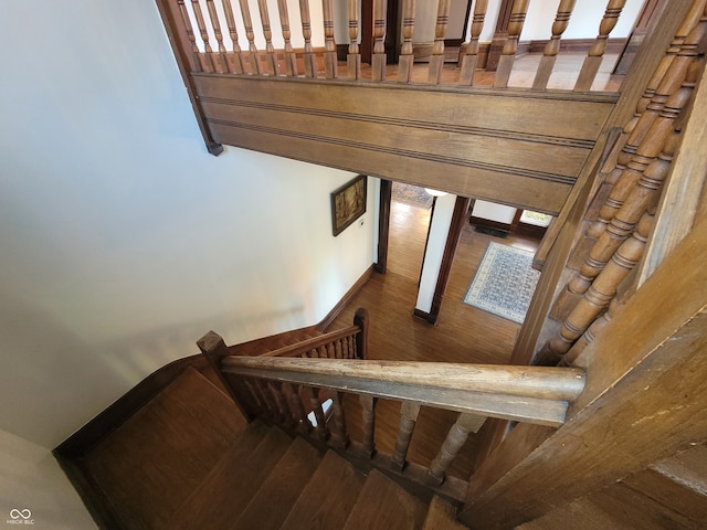 stairway with hardwood / wood-style flooring