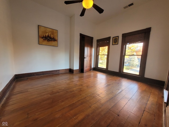 spare room featuring dark hardwood / wood-style floors and ceiling fan