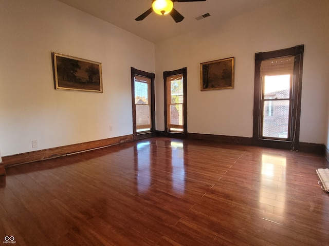 unfurnished room with ceiling fan, dark hardwood / wood-style flooring, and plenty of natural light