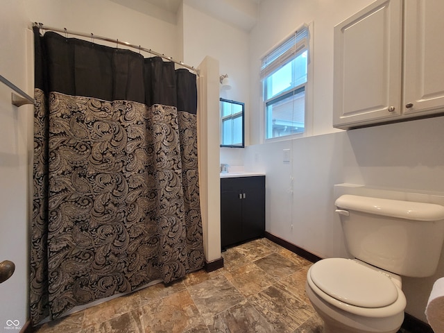 bathroom featuring toilet and vanity