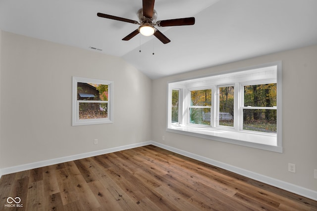 unfurnished room featuring ceiling fan, hardwood / wood-style flooring, and vaulted ceiling