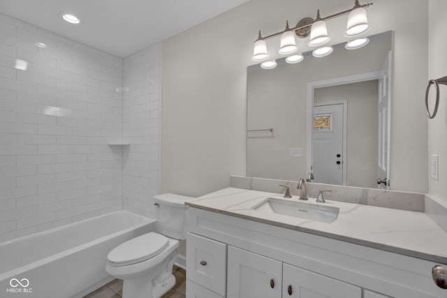 full bathroom with tiled shower / bath, vanity, toilet, and tile patterned flooring