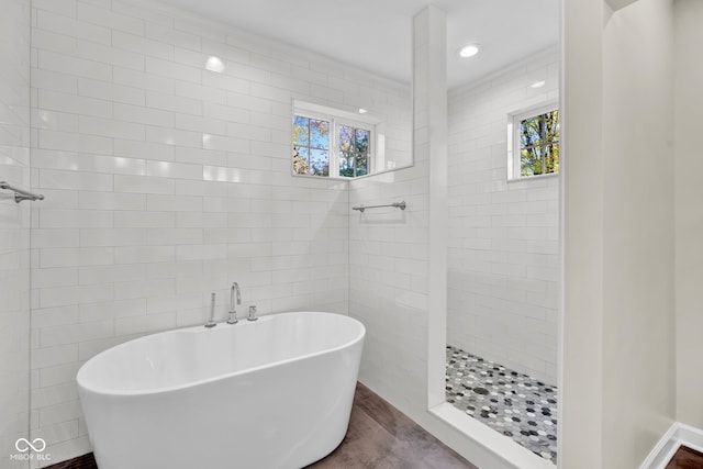 bathroom with independent shower and bath and tile walls