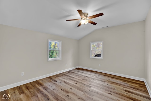 unfurnished room with vaulted ceiling, light hardwood / wood-style flooring, plenty of natural light, and ceiling fan