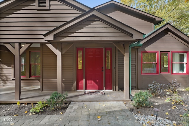 view of exterior entry featuring a porch