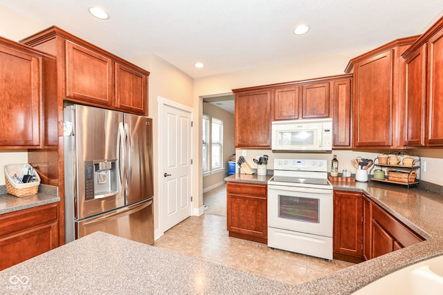 kitchen featuring white appliances and light tile patterned floors