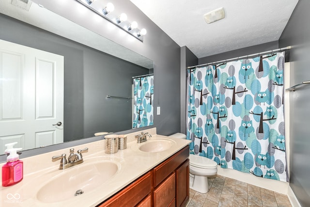 bathroom featuring vanity, a shower with shower curtain, a textured ceiling, and toilet