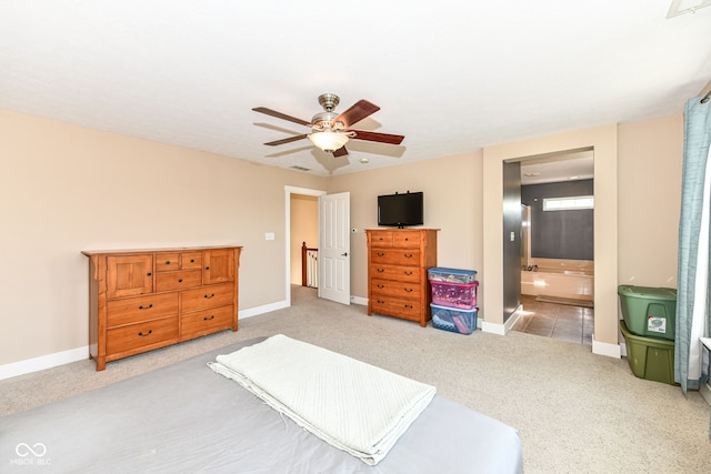 carpeted bedroom featuring ensuite bath and ceiling fan