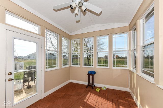 unfurnished sunroom with vaulted ceiling, ceiling fan, and plenty of natural light