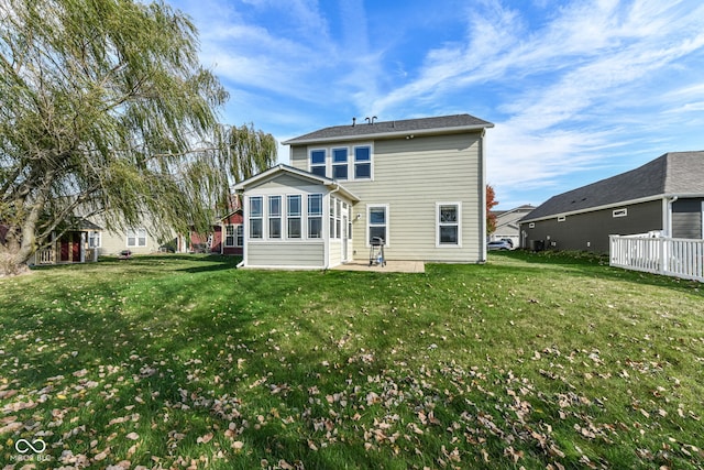 back of house featuring a lawn