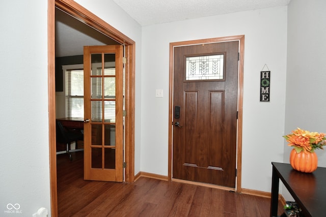 entryway featuring a textured ceiling and dark hardwood / wood-style flooring