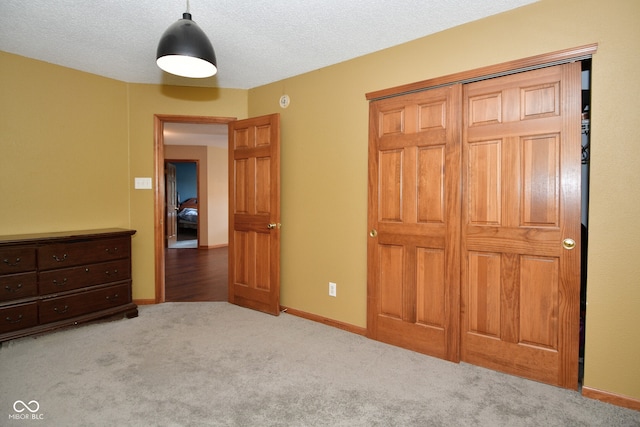 bedroom featuring light carpet and a textured ceiling