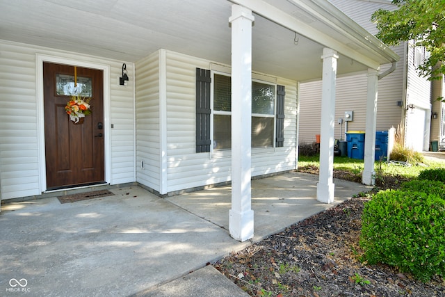 view of exterior entry with covered porch