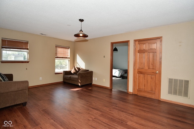 sitting room featuring a textured ceiling and dark hardwood / wood-style flooring