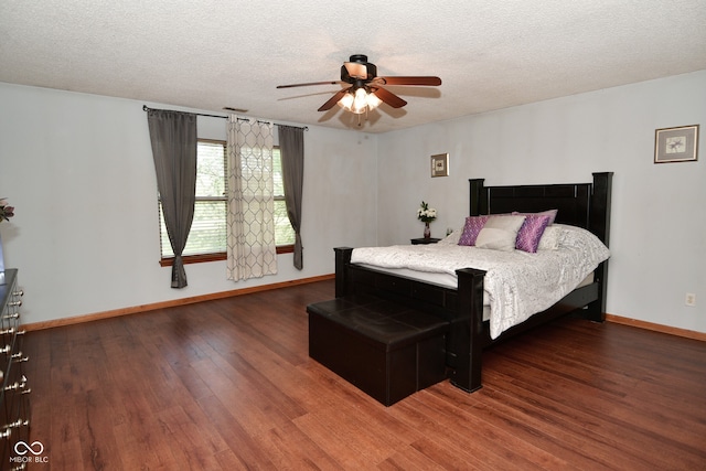 bedroom featuring a textured ceiling, ceiling fan, and dark hardwood / wood-style flooring